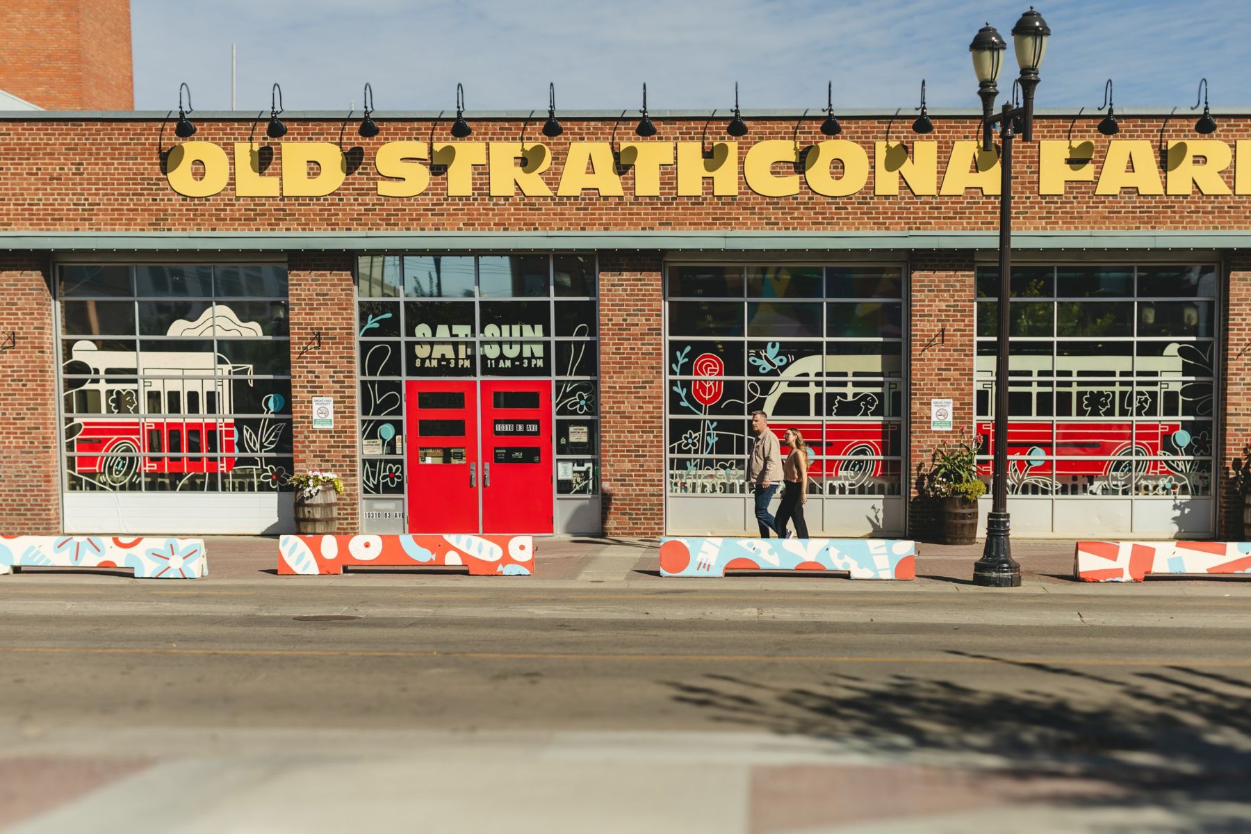 Brad and Brooklyn walking past the Old Strathcona Farmers Market